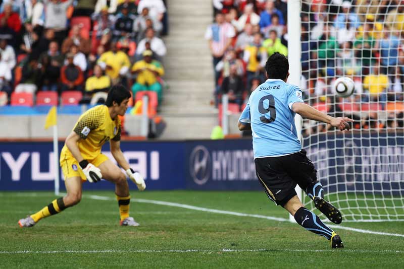 Luis Suarez opens the scoring for Uruguay against South Korea.